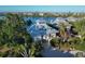 Stunning waterfront home with lush landscaping, metal roof, and inviting front porch at 38 Seawatch Lake Dr, Boca Grande, FL 33921