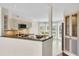 Well-equipped kitchen with granite countertops, stainless steel appliances, and a breakfast nook at 38 Seawatch Lake Dr, Boca Grande, FL 33921
