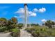 Scenic view of a historic white lighthouse surrounded by lush green vegetation and blue skies at 38 Seawatch Lake Dr, Boca Grande, FL 33921