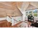 Loft with hardwood floors, white railings, wooden ceiling, and exercise equipment at 38 Seawatch Lake Dr, Boca Grande, FL 33921