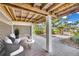 Beautifully shaded patio featuring cozy seating and access to a serene garden area at 38 Seawatch Lake Dr, Boca Grande, FL 33921