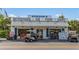 Charming storefront featuring a market, ice, and food with a golf cart parked in front at 38 Seawatch Lake Dr, Boca Grande, FL 33921