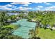 Aerial view of tennis courts surrounded by lush landscaping in a beautiful community at 38 Seawatch Lake Dr, Boca Grande, FL 33921
