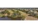 Scenic aerial view of a waterfront property surrounded by lush landscaping and mature trees at 4 Sportsman Ln, Rotonda West, FL 33947