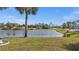 This backyard offers a serene lake view and well-maintained landscaping at 4 Sportsman Ln, Rotonda West, FL 33947