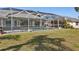 Spacious backyard with screened-in pool, well-manicured lawn, and partial views of the home at 4 Sportsman Ln, Rotonda West, FL 33947