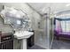 This bathroom is equipped with a step-in shower, pedestal sink, and artistic mirror at 4 Sportsman Ln, Rotonda West, FL 33947