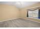 This bedroom has wood floors, cream walls, and a large double-hung window at 4 Sportsman Ln, Rotonda West, FL 33947