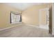 This bedroom has light hardwood floors, cream walls, and a large double-hung window at 4 Sportsman Ln, Rotonda West, FL 33947
