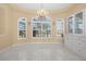 Bright dining area with a chandelier, built-in cabinets and large windows with plantation shutters at 4 Sportsman Ln, Rotonda West, FL 33947