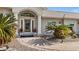 Welcoming front entrance featuring a decorative glass door framed by pillars and vibrant landscaping at 4 Sportsman Ln, Rotonda West, FL 33947