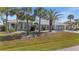 Attractive home featuring mature palm trees, meticulously landscaped front yard, and well-maintained lawn at 4 Sportsman Ln, Rotonda West, FL 33947