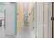 A brightly lit hallway is decorated with yellow walls and light-colored tile at 4 Sportsman Ln, Rotonda West, FL 33947