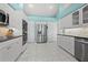 Spacious kitchen with stainless steel appliances, white cabinets, and tile floors at 4 Sportsman Ln, Rotonda West, FL 33947