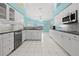 A kitchen with white cabinets, stainless steel appliances, a tile backsplash, and granite countertops at 4 Sportsman Ln, Rotonda West, FL 33947