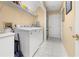 The laundry room features a washer, dryer, storage shelves, and tiled floors at 4 Sportsman Ln, Rotonda West, FL 33947