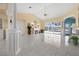 Bright living room with marble floors, a fireplace, and large sliding doors that offer views of the pool at 4 Sportsman Ln, Rotonda West, FL 33947