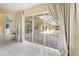 Living room with sliding glass doors leading to the screened-in pool area at 4 Sportsman Ln, Rotonda West, FL 33947