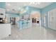 Open-concept kitchen and living area with tile floors and blue accent walls at 4 Sportsman Ln, Rotonda West, FL 33947