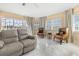 Living room with white tile floors, plush seating, and views of the pool at 4 Sportsman Ln, Rotonda West, FL 33947