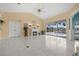 Bright living room features marble floors, a fireplace, large sliding doors, and views of the pool and outdoor area at 4 Sportsman Ln, Rotonda West, FL 33947