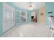 Sunny living area with white tile flooring, open shutters, and views to other rooms at 4 Sportsman Ln, Rotonda West, FL 33947