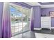 Main bedroom with large sliding glass doors and a view of the pool area at 4 Sportsman Ln, Rotonda West, FL 33947