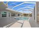 Large screened pool area with an inviting pool, spacious deck, and serene views of backyard at 4 Sportsman Ln, Rotonda West, FL 33947