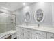 Updated bathroom with dual sinks, mirrors, marble countertop and shower at 4260 Placida Rd # 8D, Englewood, FL 34224
