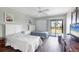 Well lit bedroom with two beds, bright windows, and sliding glass door access to the patio at 4260 Placida Rd # 8D, Englewood, FL 34224