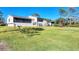Exterior view of the rear of the house highlighting a large, well-maintained lawn at 4260 Placida Rd # 8D, Englewood, FL 34224