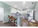 Bright kitchen featuring a breakfast bar, white cabinets, stainless steel appliances, and modern lighting at 4260 Placida Rd # 8D, Englewood, FL 34224