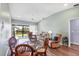Living room with vaulted ceiling, sliding glass doors, and a dining area at 4260 Placida Rd # 8D, Englewood, FL 34224