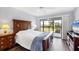 Bright main bedroom with balcony access and a view of the exterior at 4260 Placida Rd # 8D, Englewood, FL 34224