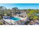 Community pool surrounded by lush greenery providing a serene oasis for residents to enjoy at 4260 Placida Rd # 8D, Englewood, FL 34224