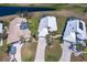 Aerial view showcases the roof, driveway, landscaping, and the surrounding neighborhood at 6 Windward Ct, Placida, FL 33946