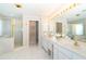 Elegant bathroom with double sinks, a large mirror, and a glass-enclosed shower at 6 Windward Ct, Placida, FL 33946