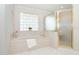 Relaxing bathroom with a large tub and separate glass shower at 6 Windward Ct, Placida, FL 33946