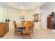Traditional dining room with decorative chandelier, light yellow walls, tile flooring, and wooden dining table at 6 Windward Ct, Placida, FL 33946