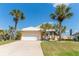 Charming single Gathering home with a white tile roof, lush landscaping and a two car garage at 6 Windward Ct, Placida, FL 33946