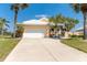 Charming single Gathering home with a white tile roof, lush landscaping and a two car garage at 6 Windward Ct, Placida, FL 33946