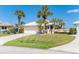 Charming single Gathering home with a white tile roof, lush landscaping and a two car garage at 6 Windward Ct, Placida, FL 33946