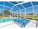 Screened-in lanai showcasing a pristine pool and a relaxing in-ground hot tub, perfect for unwinding outdoors at 6 Windward Ct, Placida, FL 33946