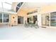Spacious outdoor lanai featuring a dining table set for six, with a seamless transition to the home's interior at 6 Windward Ct, Placida, FL 33946