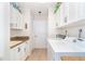 Well-lit laundry room features white cabinets, counter space and modern washer and dryer at 6 Windward Ct, Placida, FL 33946