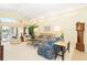 Inviting living room with high ceilings, neutral tones, comfortable seating, and sliding glass doors to the lanai at 6 Windward Ct, Placida, FL 33946