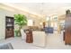 Bright living room featuring vaulted ceiling, comfortable seating, large windows, and access to dining area at 6 Windward Ct, Placida, FL 33946