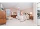 Spacious main bedroom featuring a tray ceiling and a large window at 6 Windward Ct, Placida, FL 33946