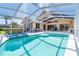 Spacious outdoor area features a screened-in pool and hot tub area, with an outdoor table for entertaining guests at 6 Windward Ct, Placida, FL 33946