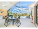 A luxurious screened-in lanai features a private pool, dining table set, and inviting lounge area with outdoor views at 6 Windward Ct, Placida, FL 33946
